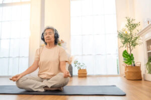 Happy Asian Senior Woman Meditating 600nw 2655273401 300x200